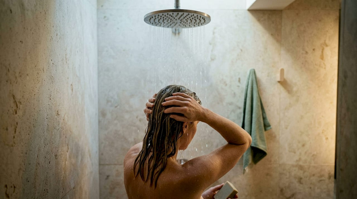 Woman rinsing hair during shampoo bar transition