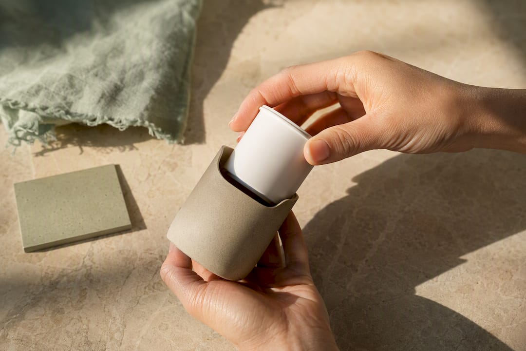 Hands fitting a refill pod into packaging