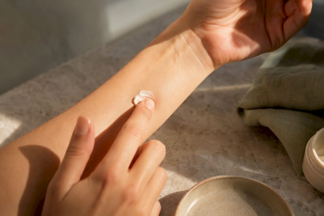 Hand patch testing skincare on forearm