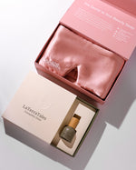 Silk sleep mask and serum in a branded box on a light background