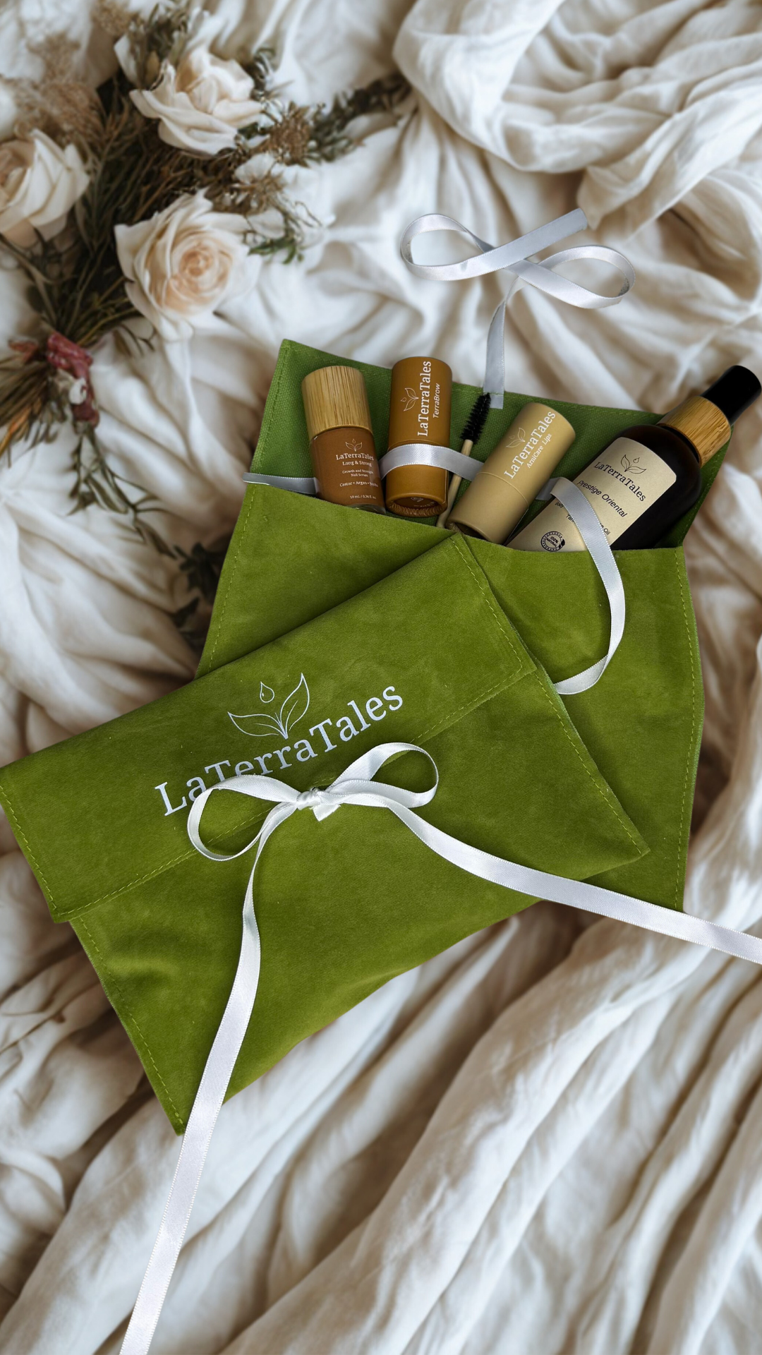 Green LaTerraTales pouch with cosmetic bottles on a soft fabric background